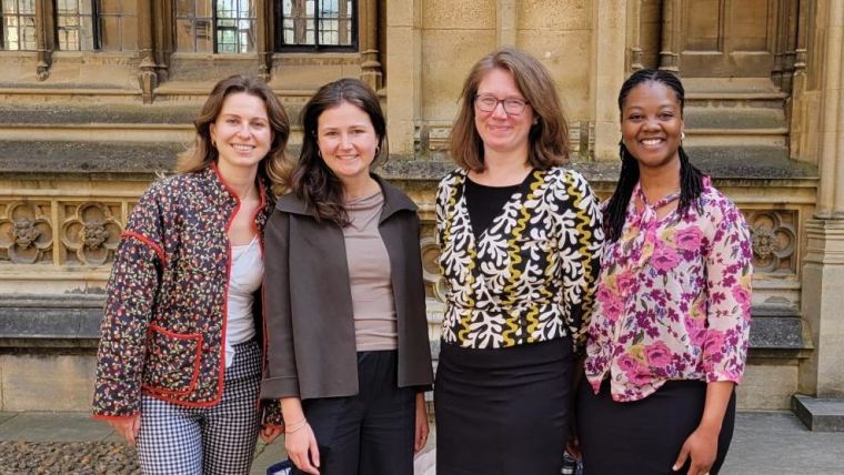4 members of the GloPID-R team standing in front of historic Oxford building.