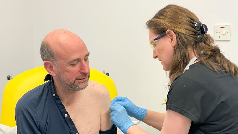 Participant receives vaccine from health professional